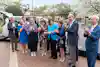 a group of people standing together and clapping