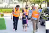 a group of people walking with a child