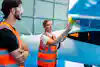 a man and woman in orange vests