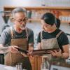 a man and woman looking at a tablet