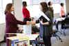 a woman shaking hands with another woman