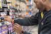 a man looking at a shelf of yogurt