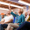 Woman Asking Question At Neighborhood Meeting In Community Center