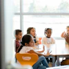 a group of children sitting at a table