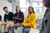 Group of colleagues having a brainstorming session at office. Multi-ethnic business people sitting in circle and discussing new strategies