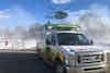 a ambulance with a helicopter above it