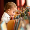 a baby looking at books