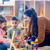 a woman and children playing with toys