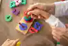 a child and adult playing with colorful toys