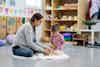 a woman and a child playing with toys