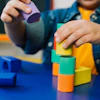 a child playing with colorful blocks
