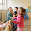 a group of kids playing tug of war