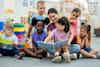 a group of children reading a book