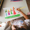 a child drawing on a white paper