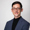 a man wearing glasses and a suit