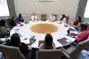 a group of women sitting around a round table