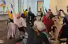 a group of people in a room with their arms raised