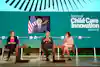 a group of people sitting in chairs on a stage