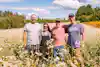 a group of people standing in a field of flowers