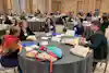 a group of people sitting around a round table