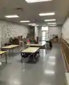 a classroom with tables and chairs