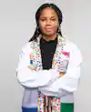 a woman with braids wearing a white lab coat with colorful design