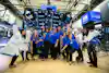 a group of women in blue shirts