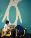 two children playing in chairs