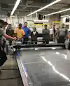 a group of people standing around a large machine