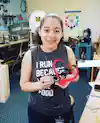 a girl holding a heart shaped object