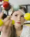a girl holding a model of a molecule
