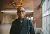 a man wearing glasses and a backpack