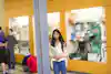 a woman standing in a store holding a book