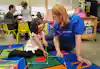 a woman and a girl playing with toys
