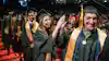 a group of people in graduation gowns and caps