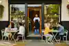 a man standing in front of a restaurant