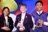 a group of people holding trophies
