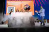 a group of people standing around a table with smoke