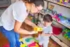 a woman and a child playing with a toy