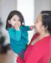 a woman holding a baby