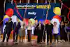 a group of people standing on a stage with streamers