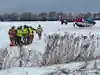 a group of people in safety gear in a snowy field