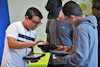 a group of young men looking at electronic devices