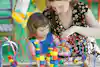 a woman and a child playing with toys
