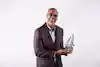 a man holding a glass award